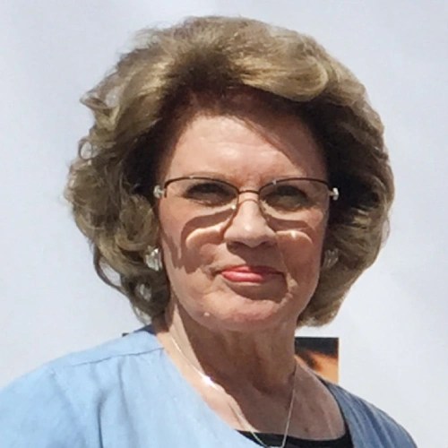 A woman with glasses and a blue shirt