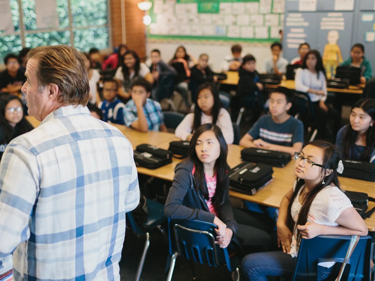 A man standing in front of a group of students