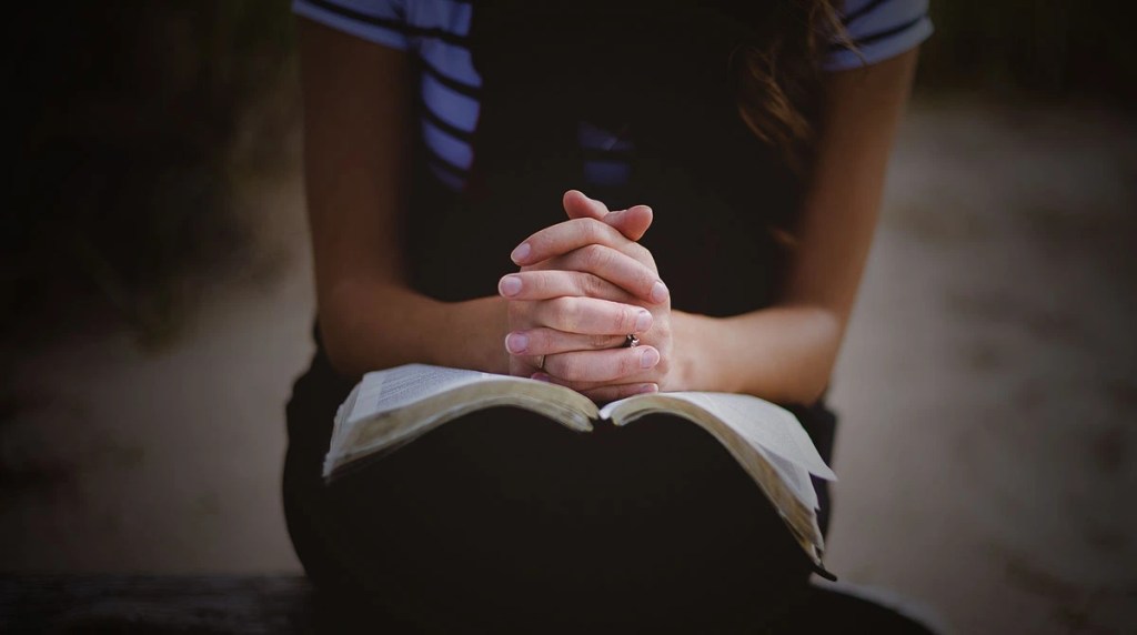 Woman praying over her bible