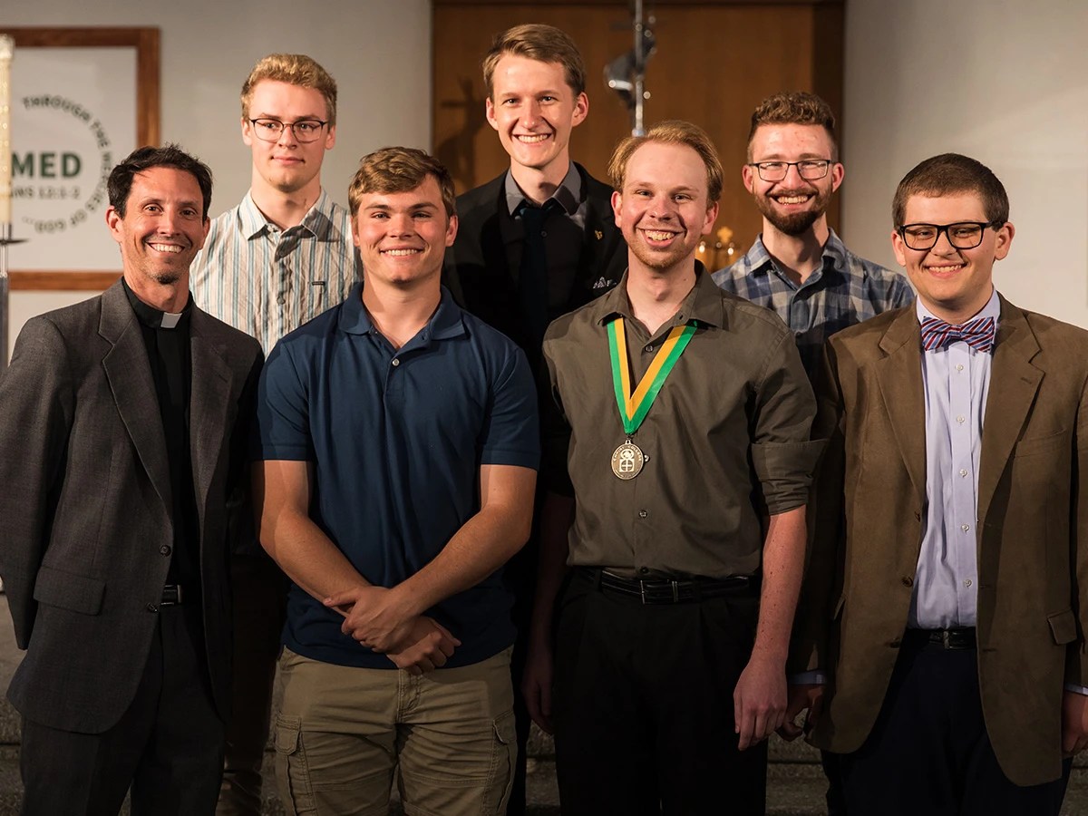 A group of men posing for a photo