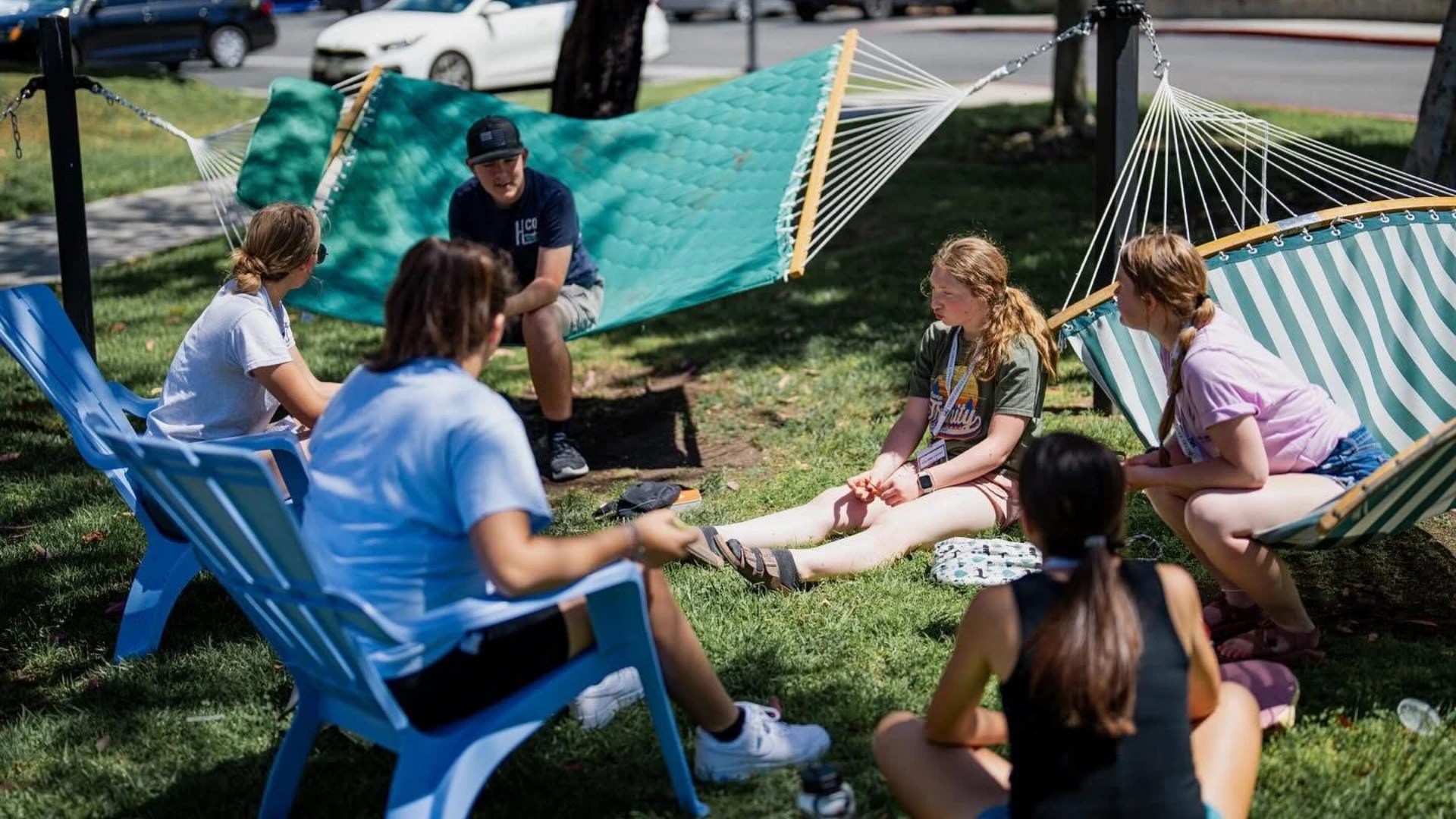 A group of people sitting in chairs and hammocks
