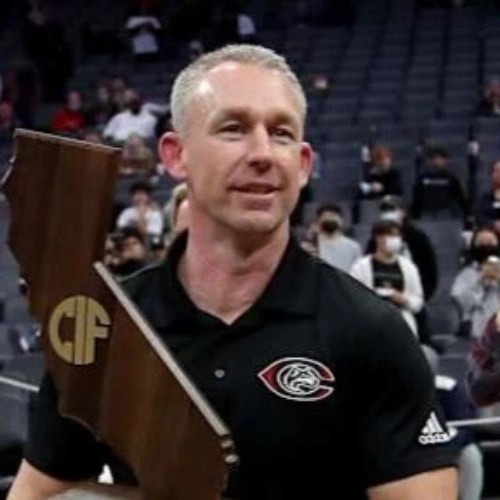 A man holding a trophy