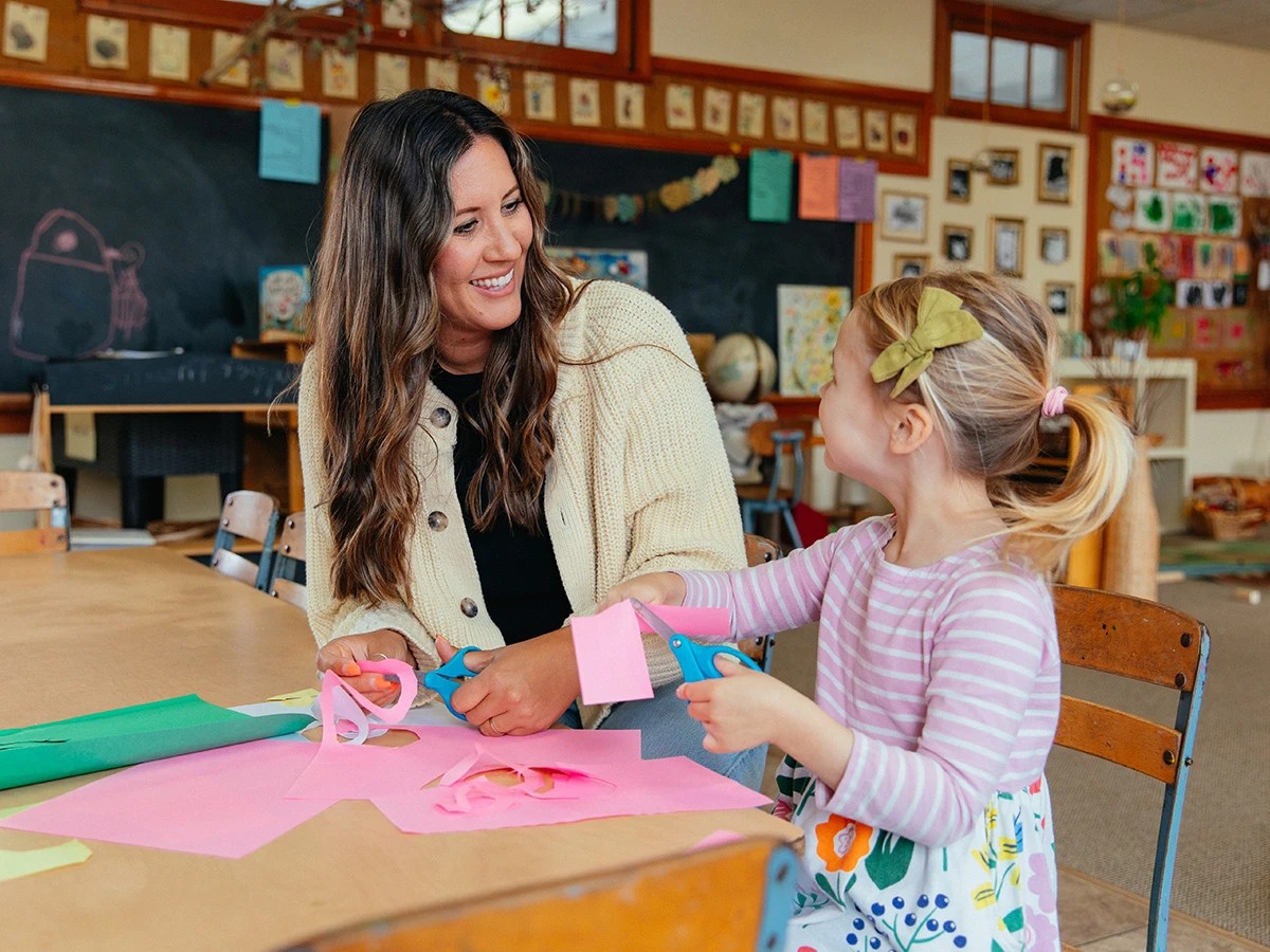 A woman and a child cutting paper