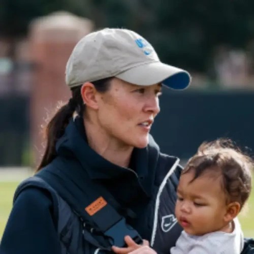 A woman carrying a baby