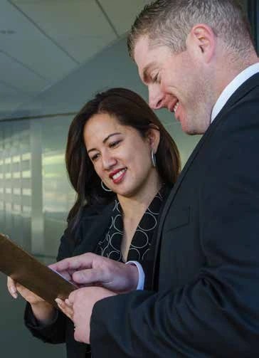A man and woman looking at a piece of paper
