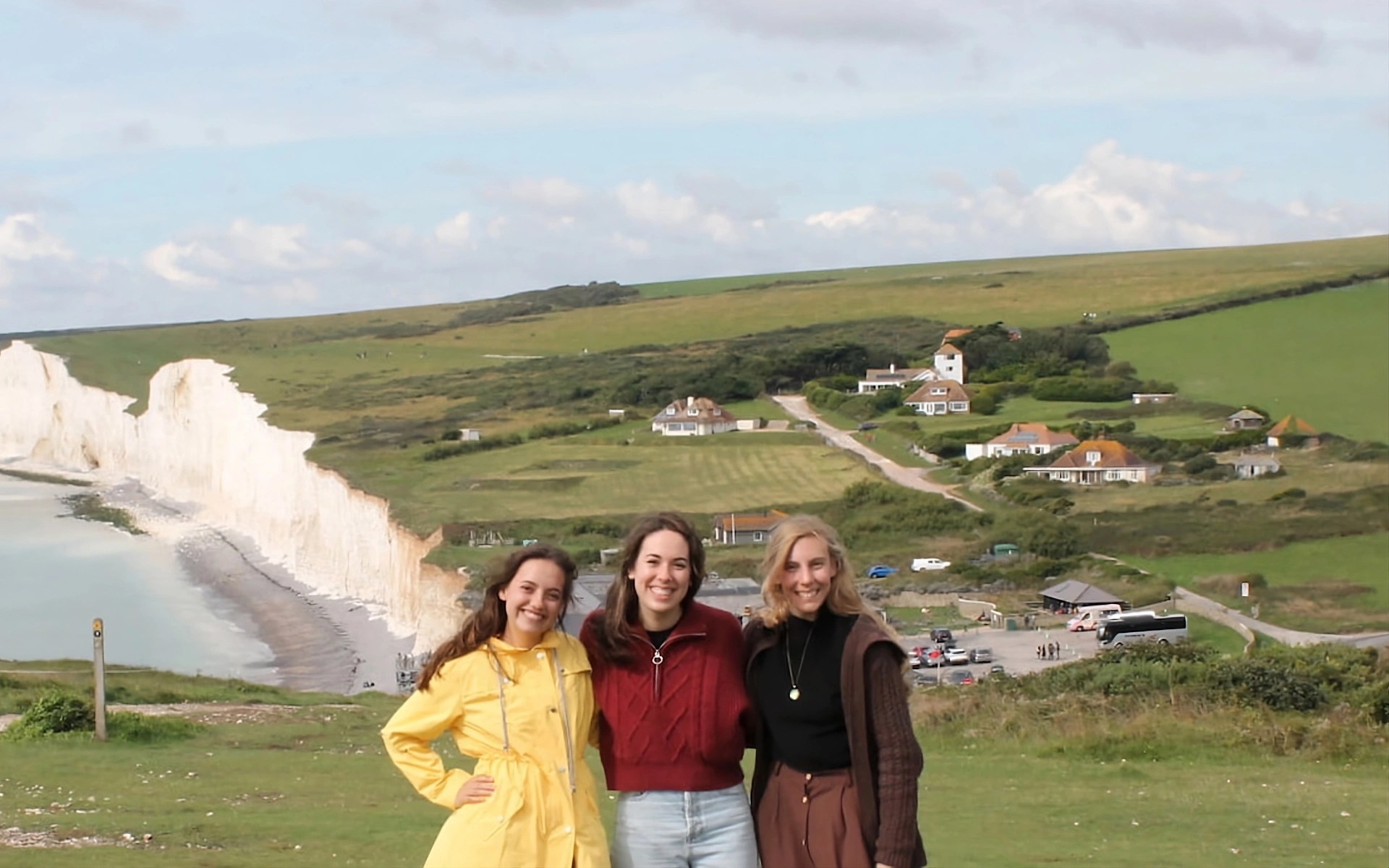 A group of women standing in a grassy area