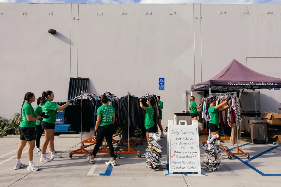 A group of people in green shirts
