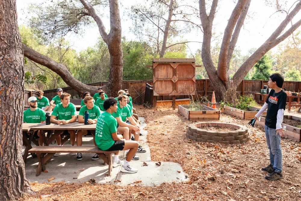 A group of people sitting at a picnic table