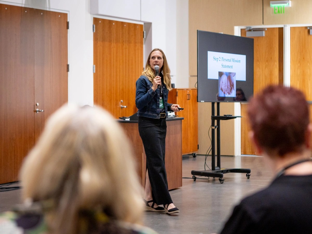 A woman standing in front of a microphone
