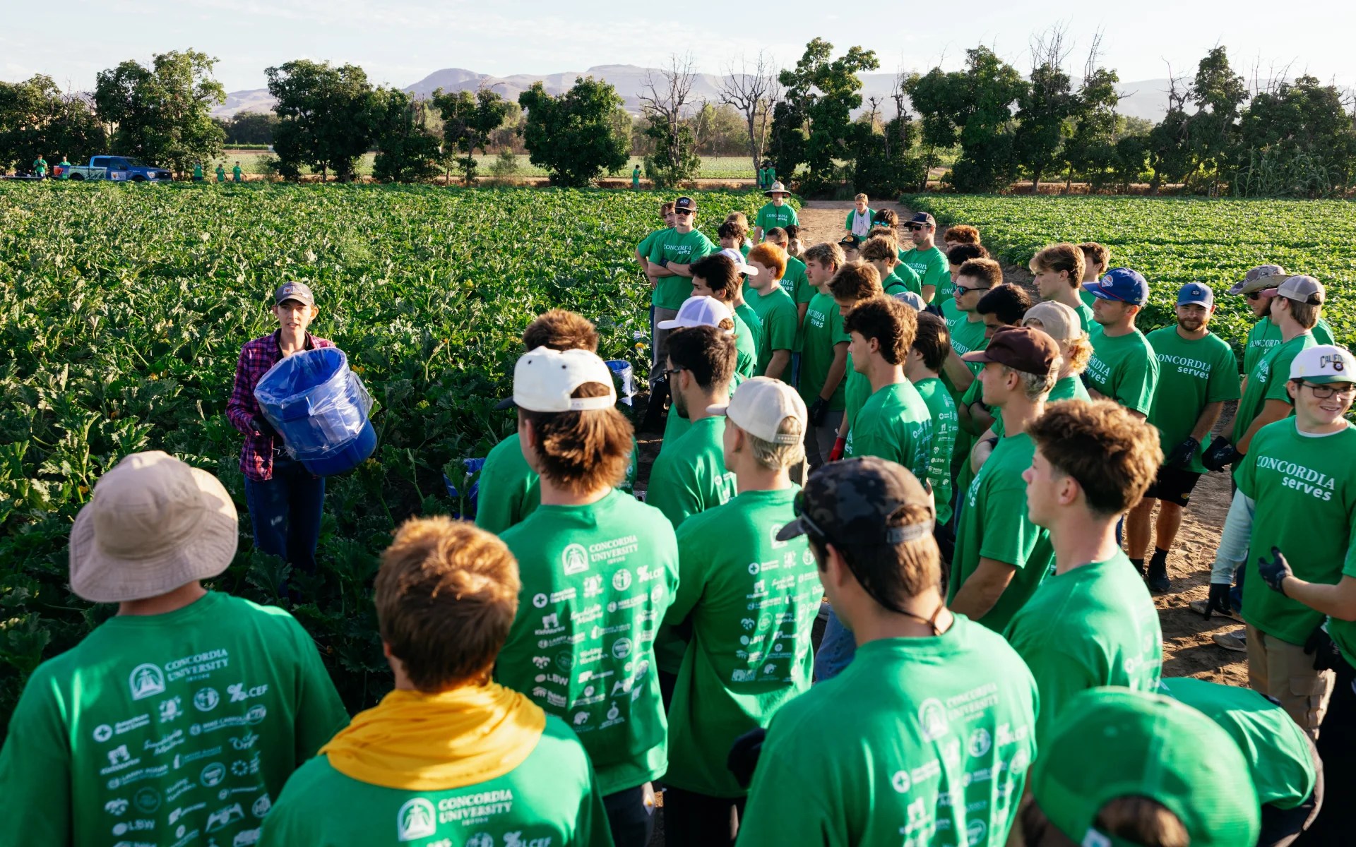 A group of people in green shirts