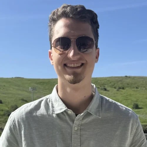 A man wearing sunglasses and smiling