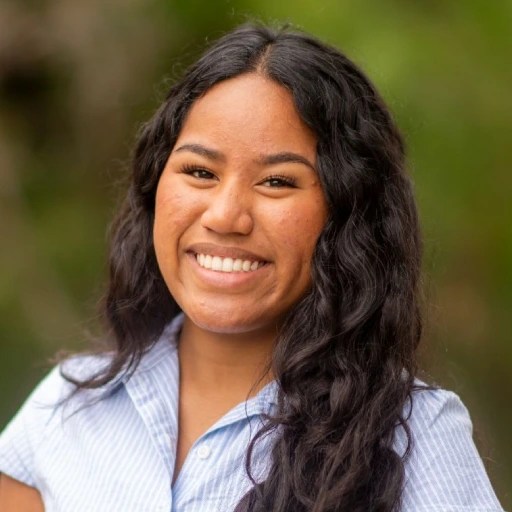 A woman with long black hair smiling