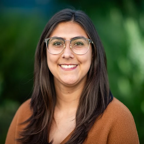 A woman with long hair wearing glasses