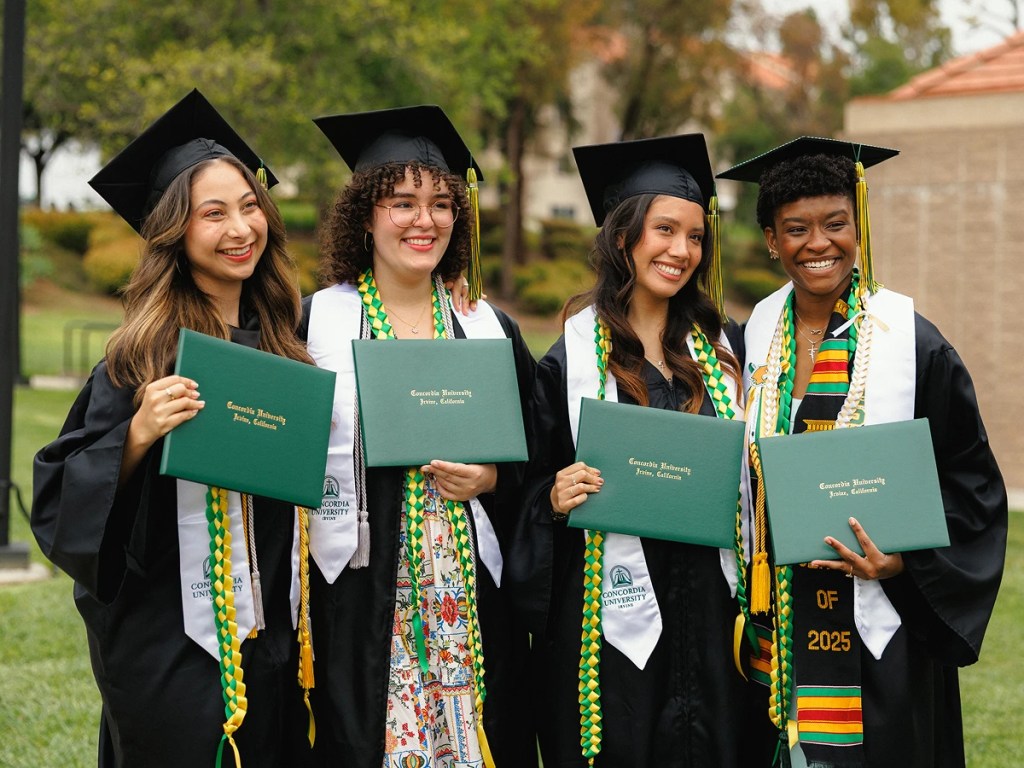 A group of women in graduation gowns and caps