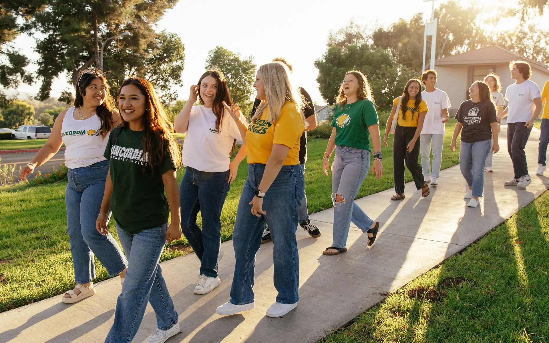 A group of people walking on a sidewalk