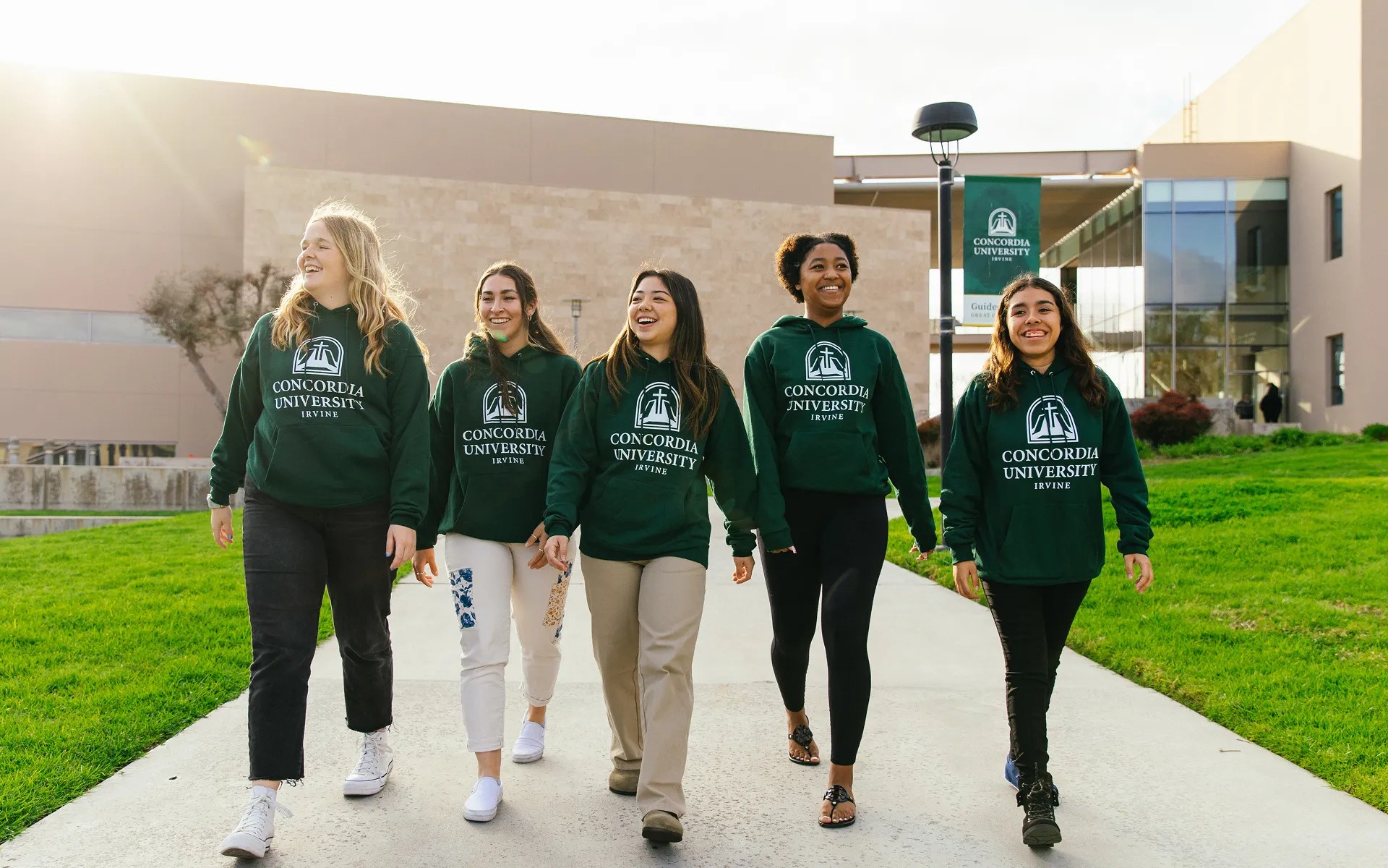 A group of women walking on a sidewalk