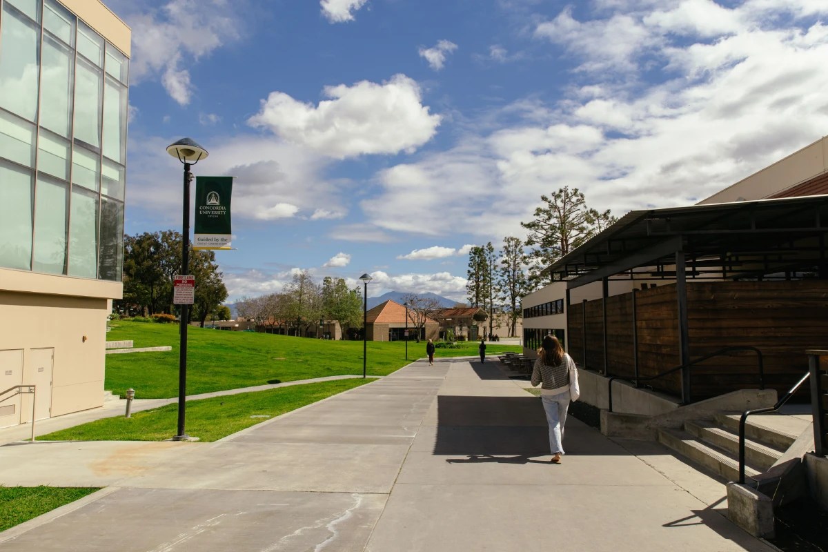 A woman walking on a sidewalk