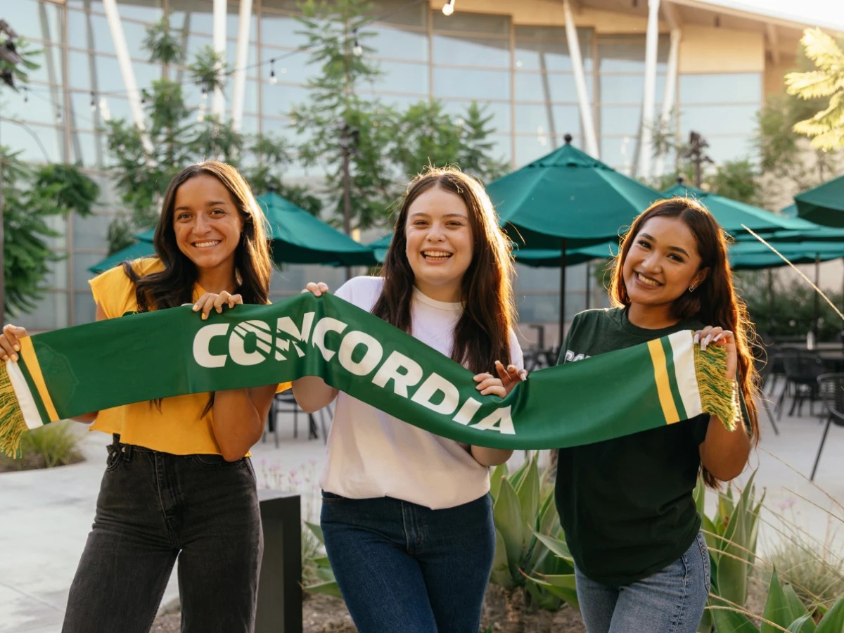 A group of women holding a green scarf