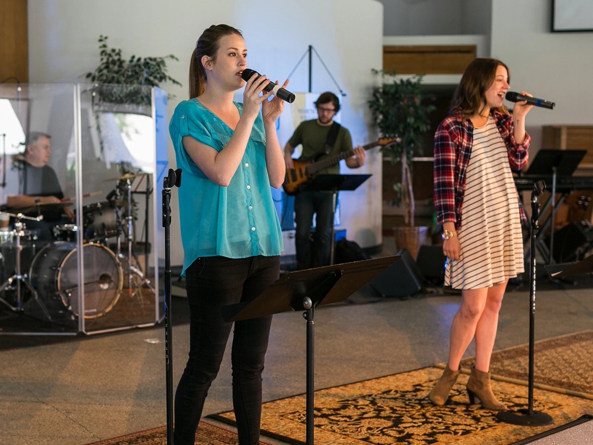 A group of people singing on a stage