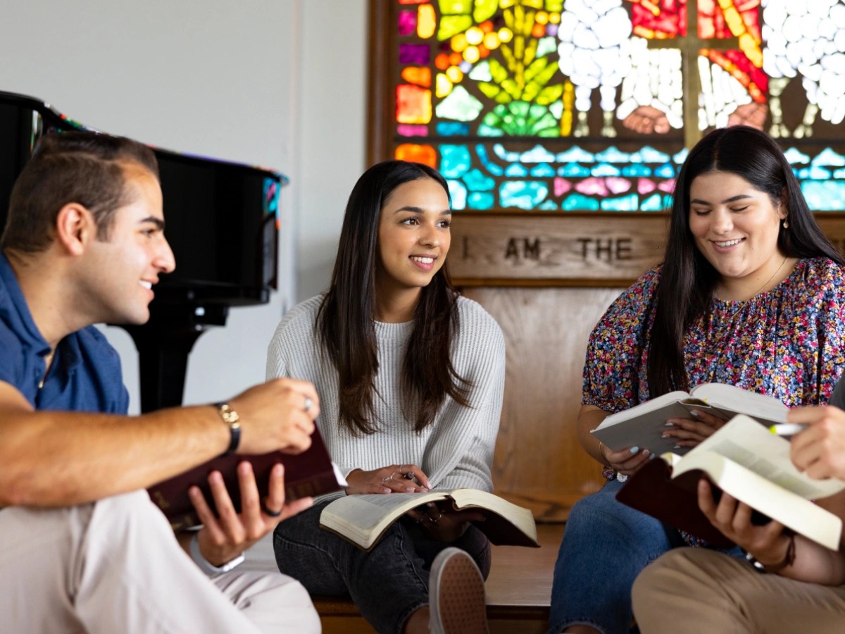A group of people sitting and reading books