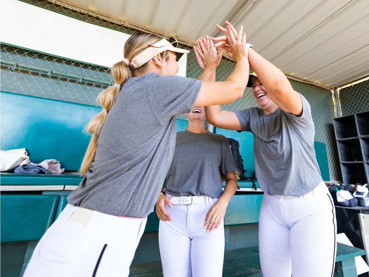 A group of women in uniform giving each other a high five