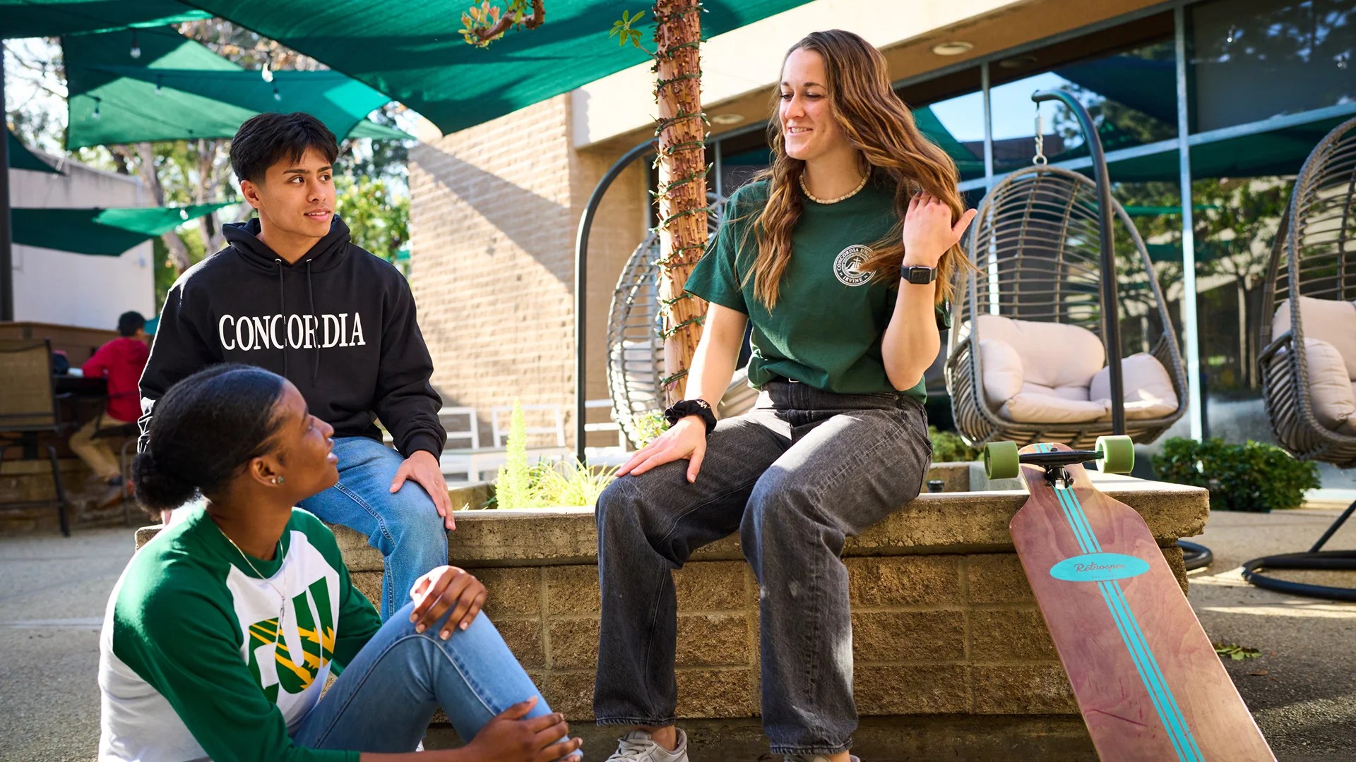 A group of people sitting on a ledge