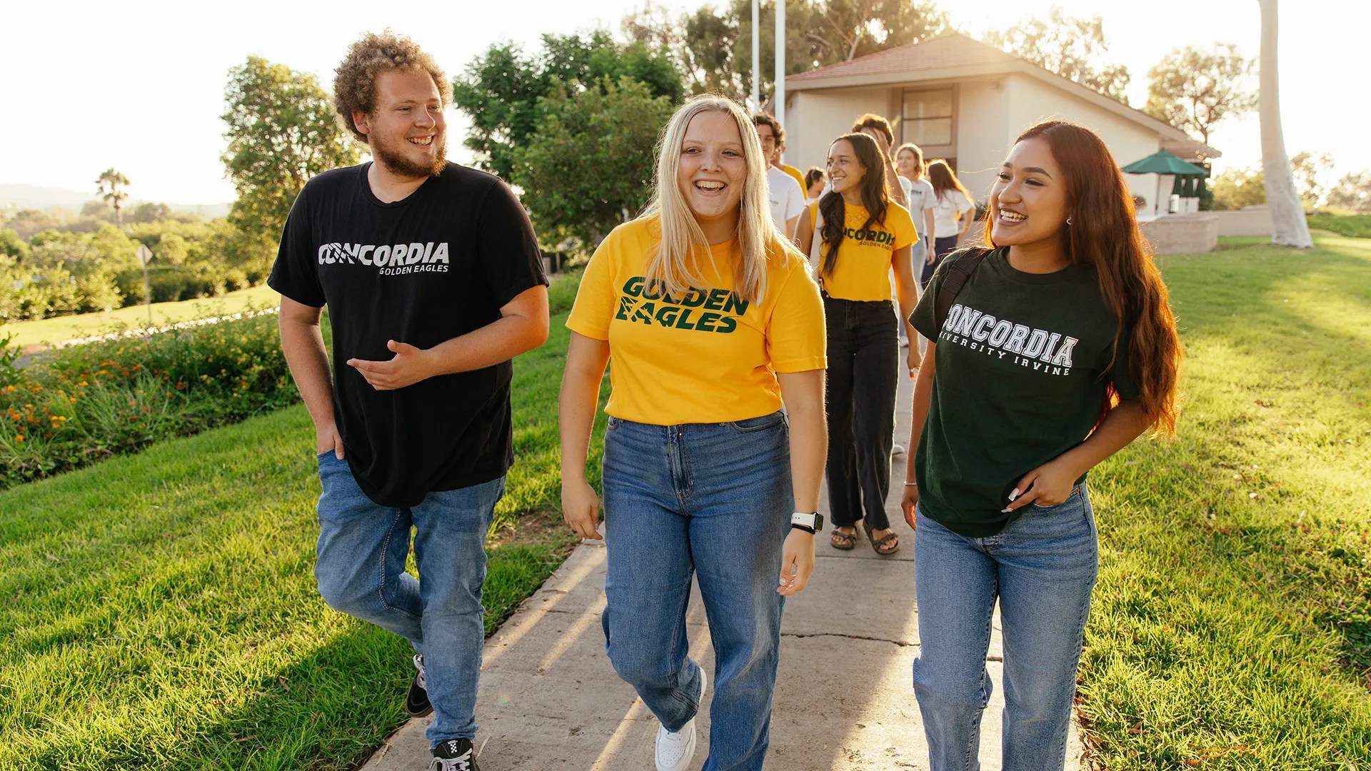 A group of people walking on a sidewalk