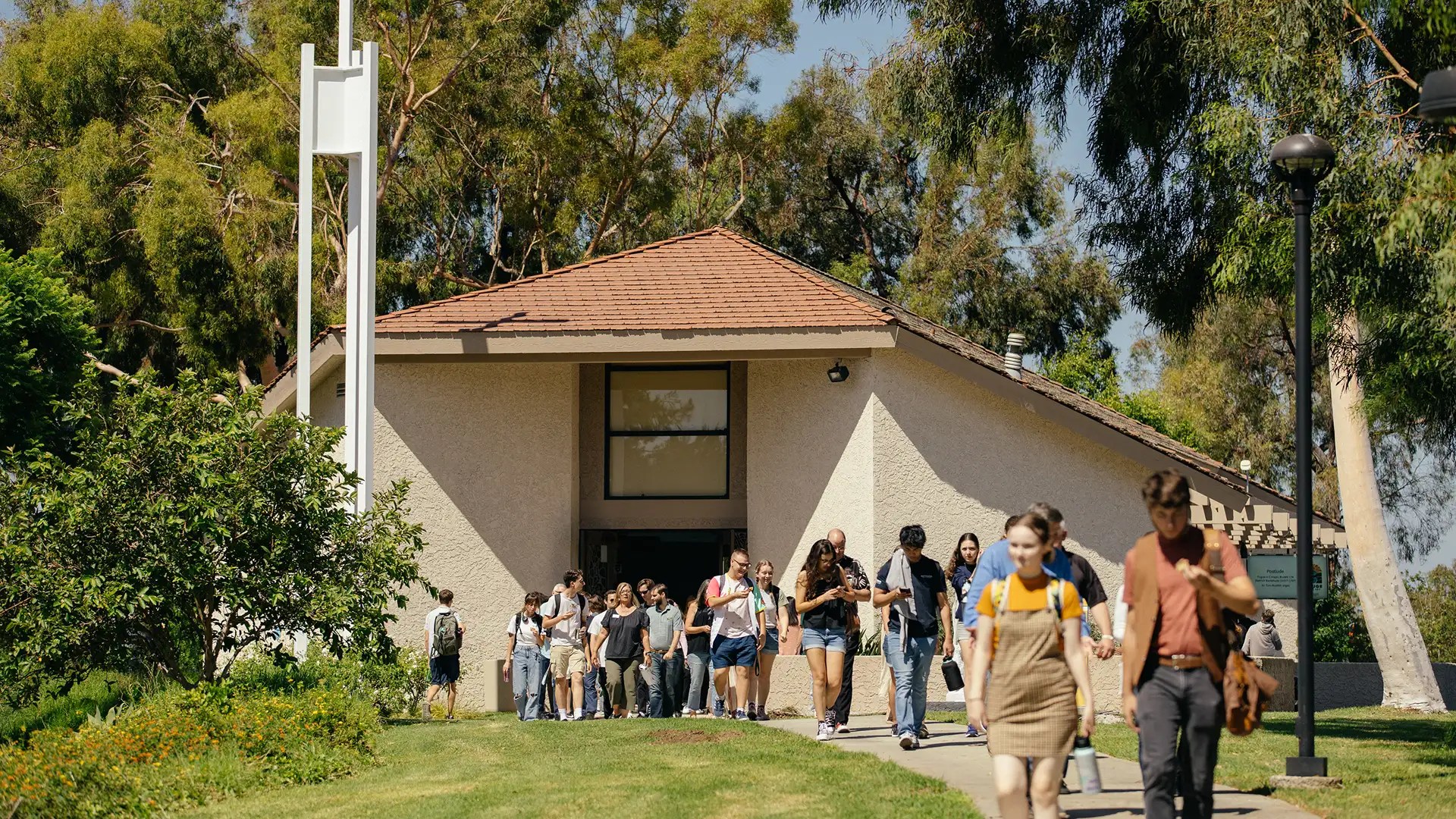 A group of people walking out of a building