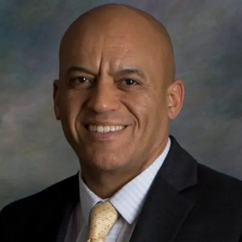 A man in a suit smiling