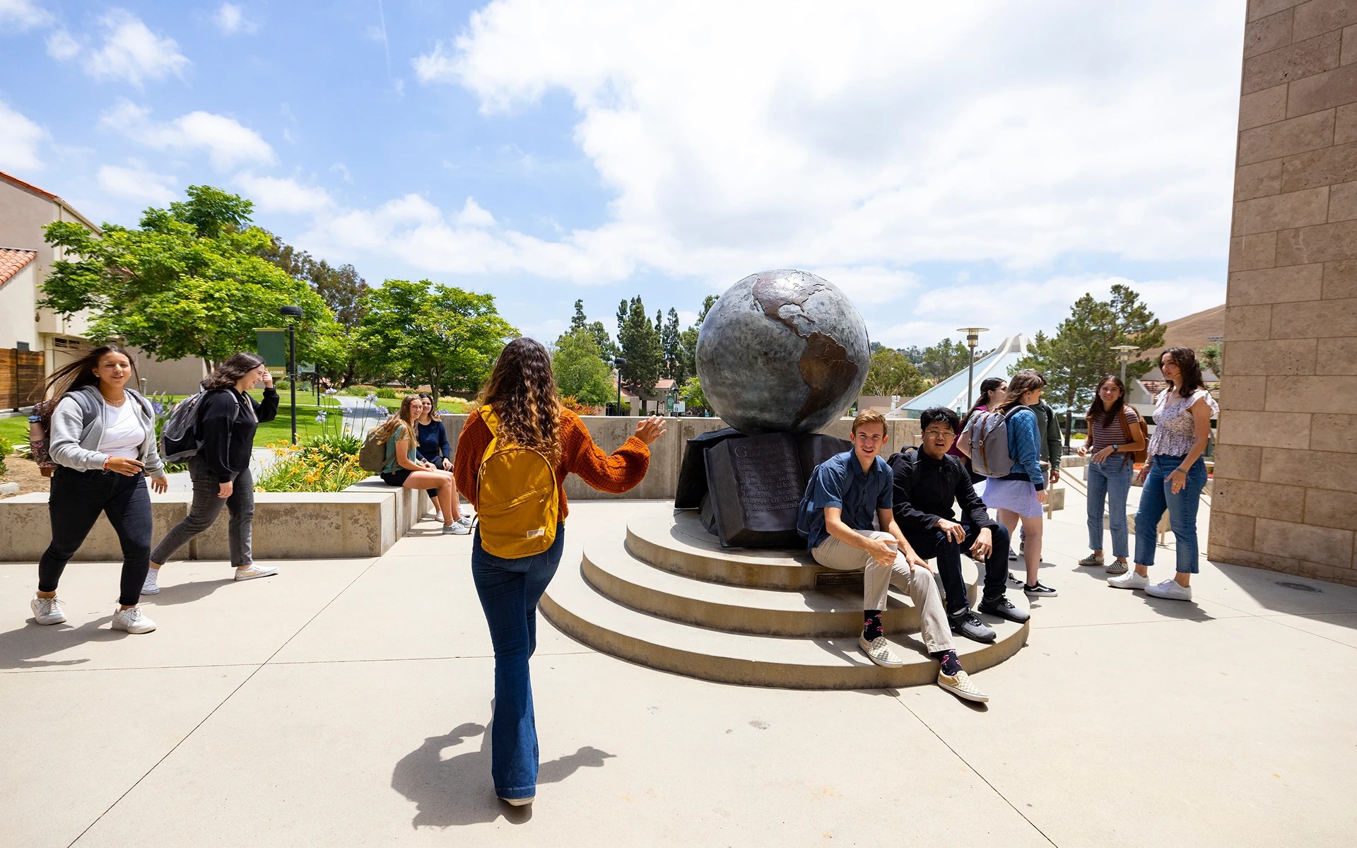 A group of people around a statue