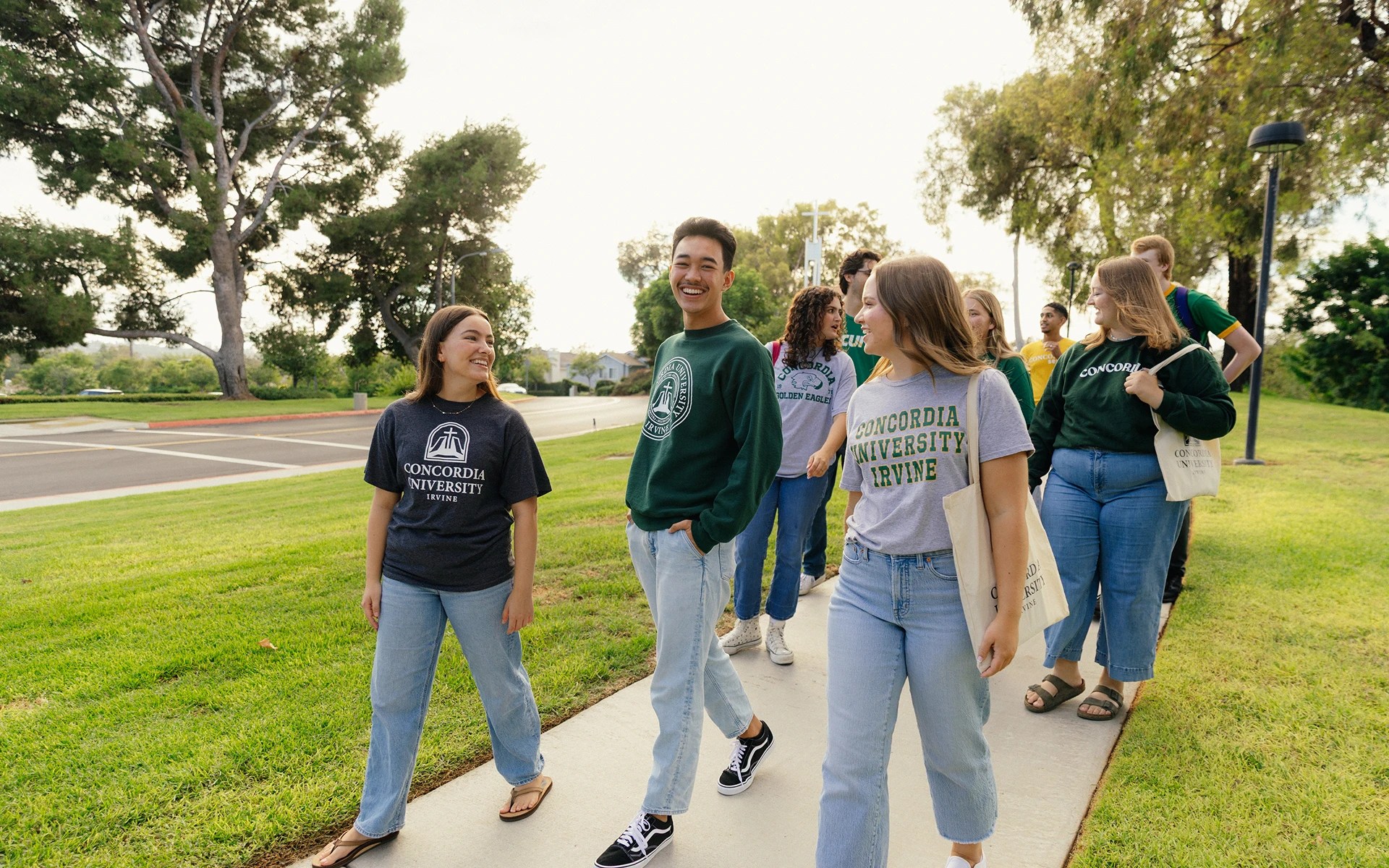 A group of people walking on a sidewalk