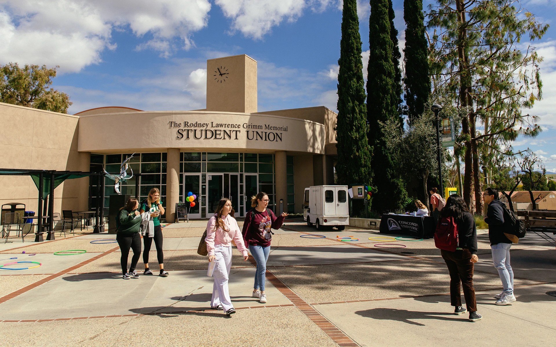 A group of people walking outside of a building