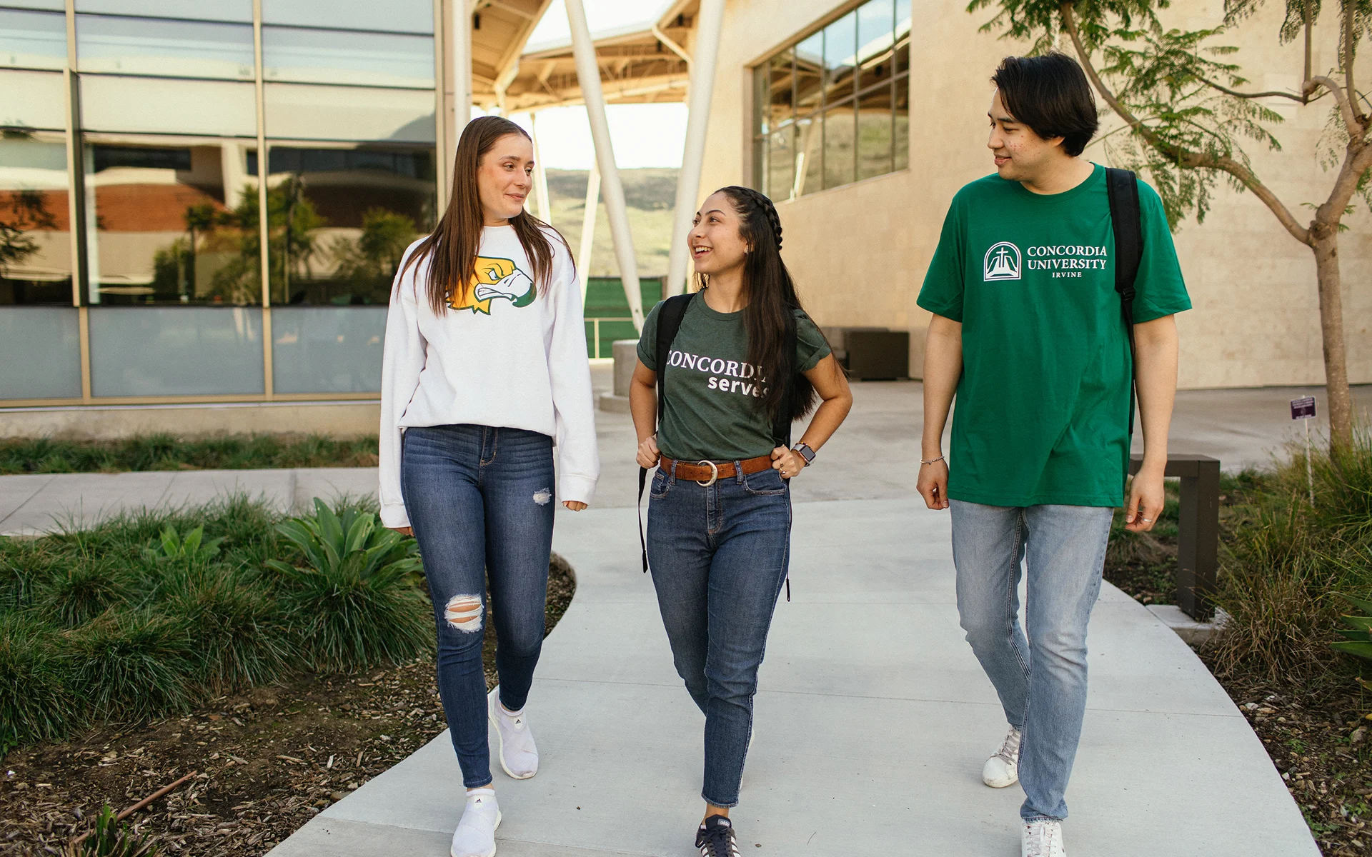 A group of people walking on a sidewalk