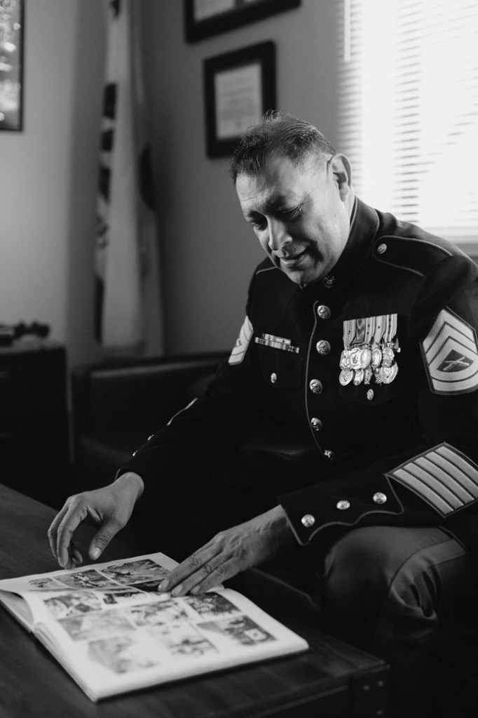 A man in military uniform reading a book