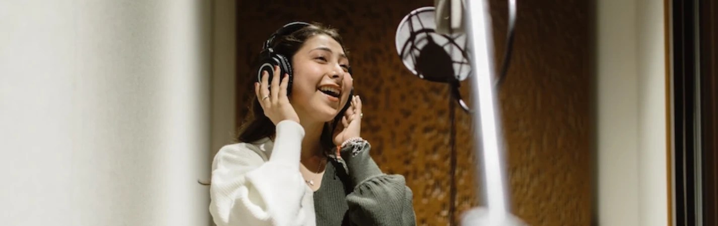 A woman wearing headphones and smiling