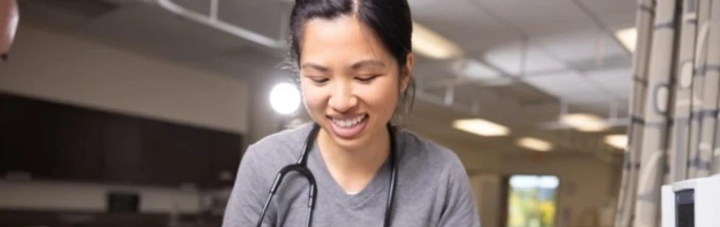 A woman with a stethoscope around her neck