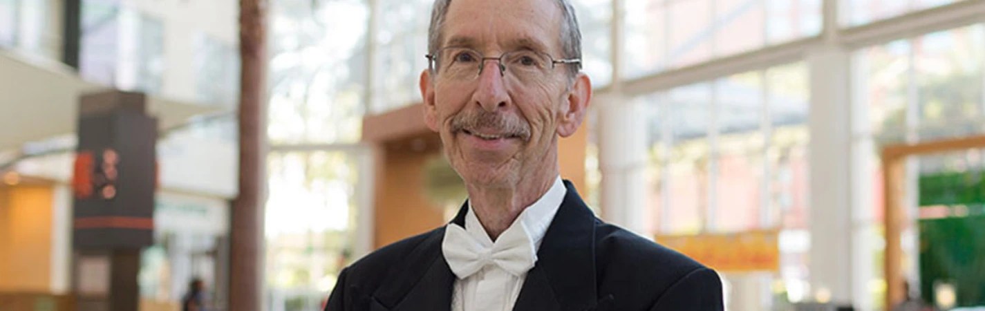 A man in a suit and bow tie
