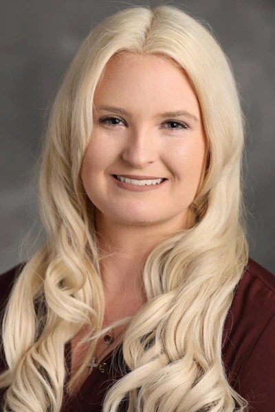 A woman with blonde hair smiling