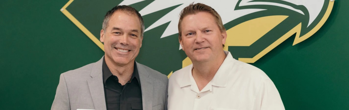 Two men standing together smiling