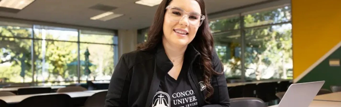 A woman wearing glasses and a black jacket