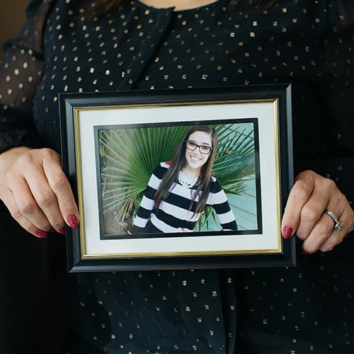 A person holding a picture of a woman