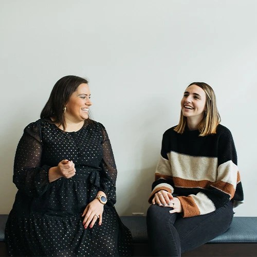 Two women sitting on a bench