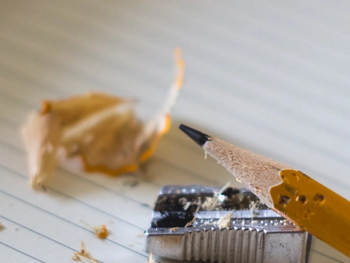 A pencil and sharpener on a piece of paper