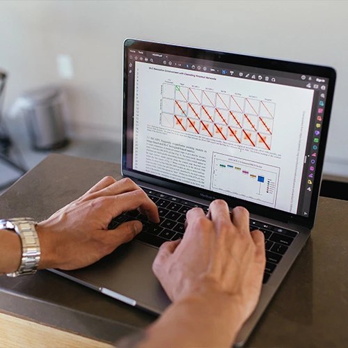 A person typing on a laptop