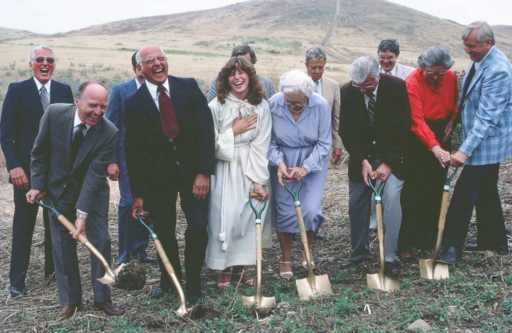 A group of people digging in the ground