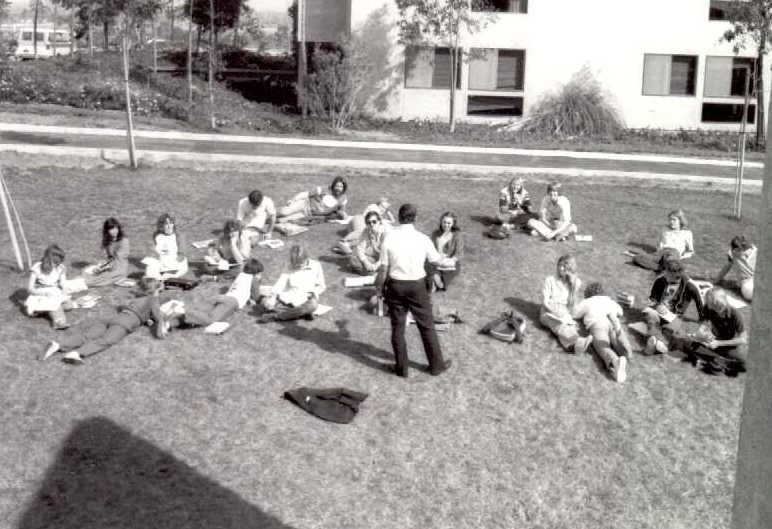 A group of people sitting on the grass