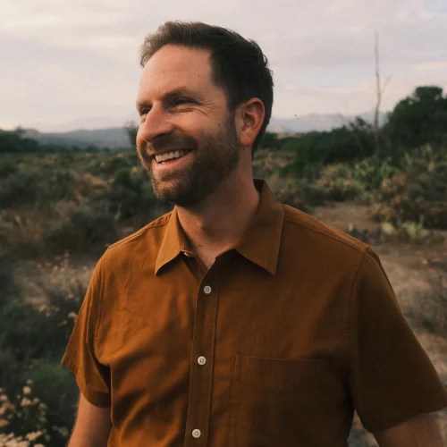 A man smiling in a field