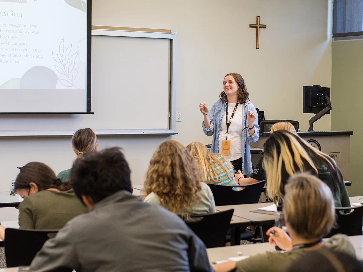 A woman standing in front of a classroom