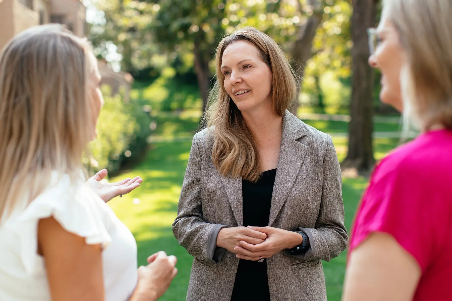 A group of women talking in a park