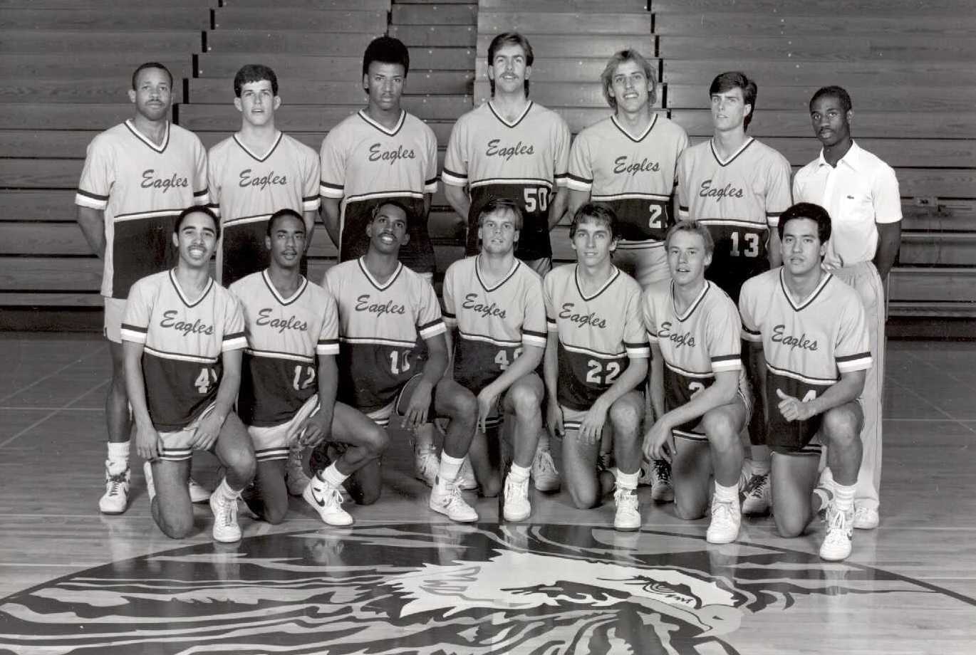 A group of men in basketball uniforms posing for a photo